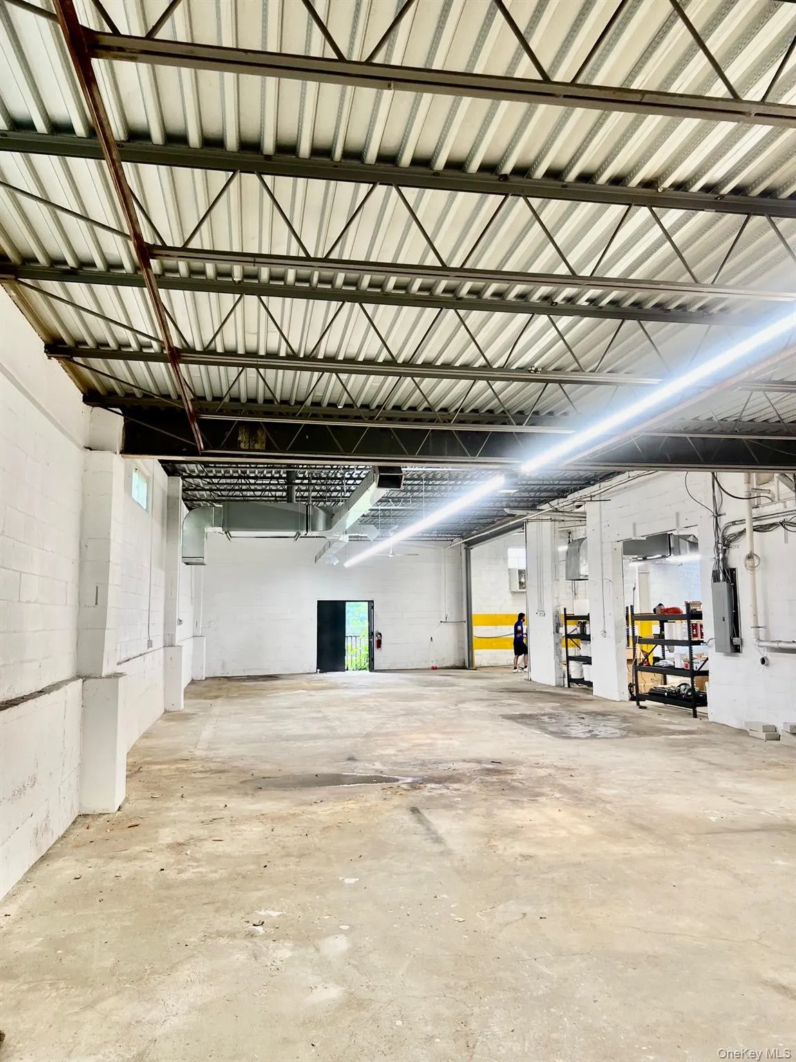 Garage featuring electric panel and concrete block wall Garage featuring electric panel and concrete block wall