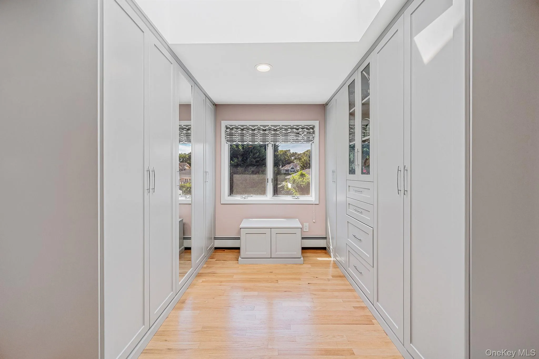 Corridor featuring light wood-style flooring and recessed lighting Corridor featuring light wood-style flooring and recessed lighting