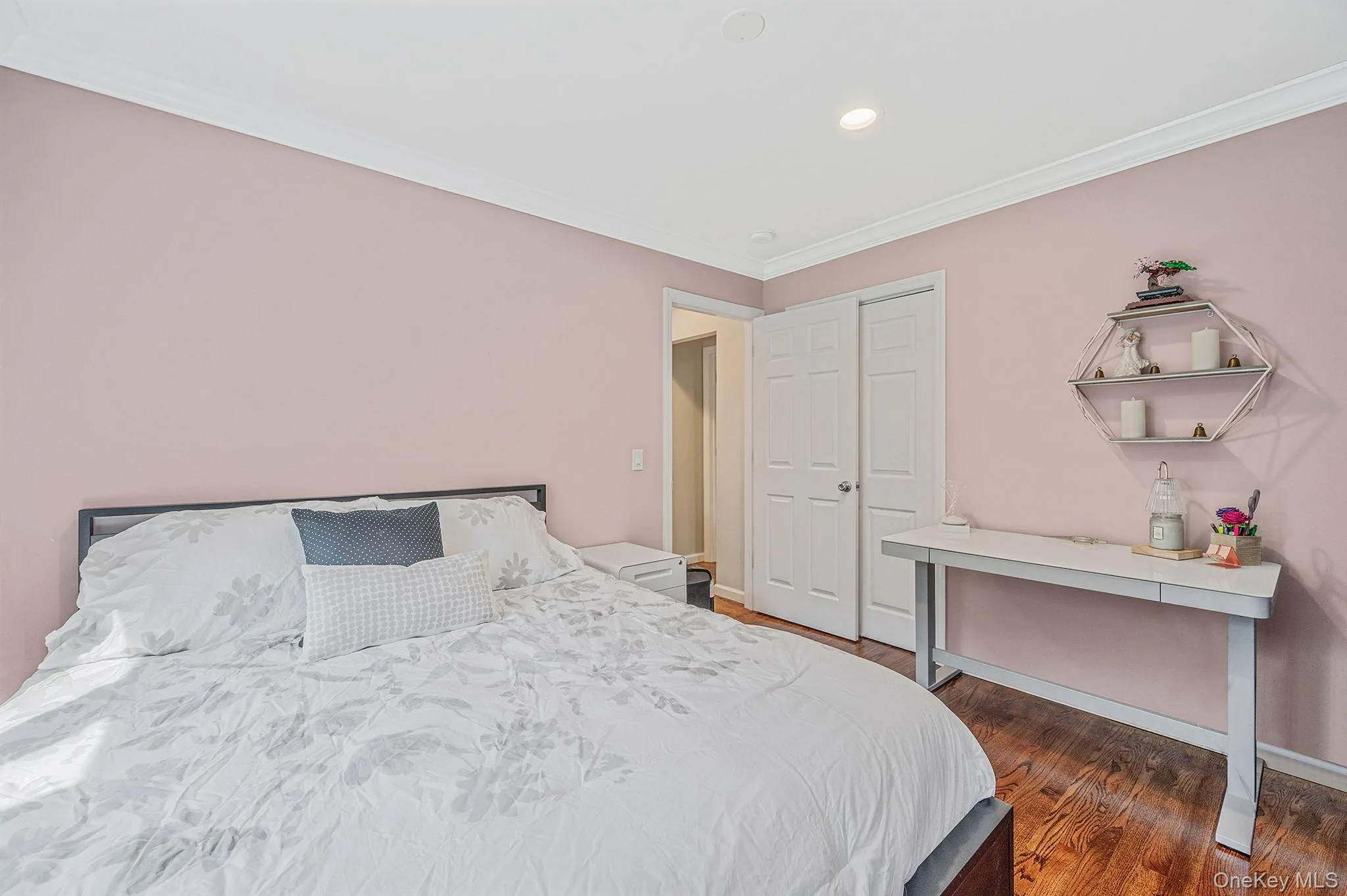 Bedroom with crown molding, dark wood finished floors, and recessed lighting Bedroom with crown molding, dark wood finished floors, and recessed lighting