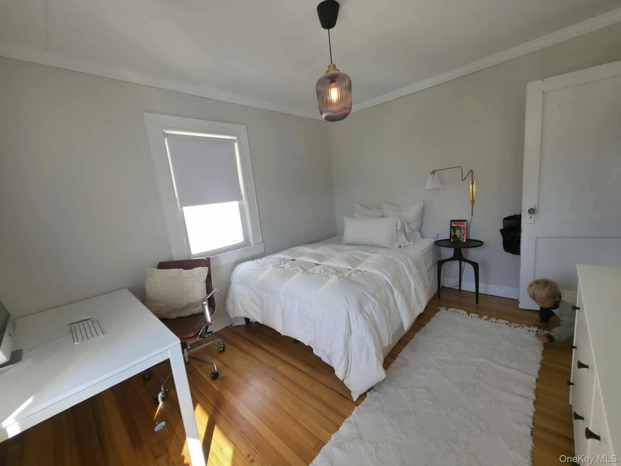 Bedroom with light wood-type flooring and crown molding Bedroom with light wood-type flooring and crown molding