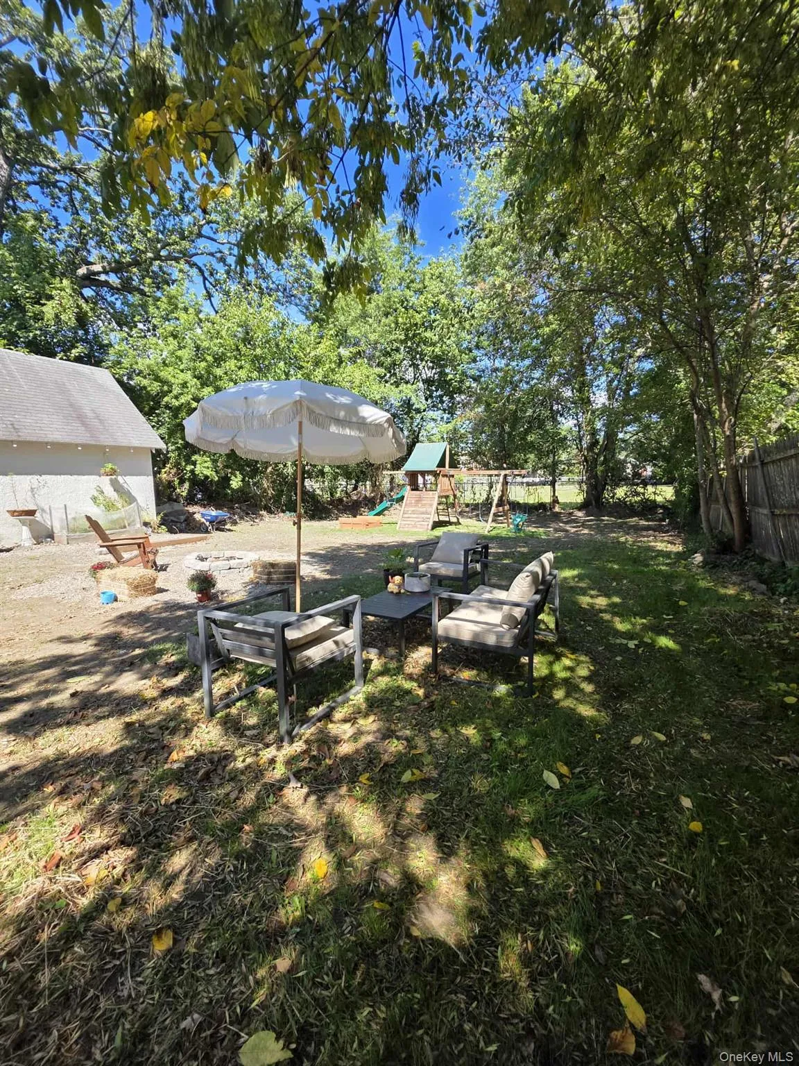 View of grassy yard with a playground and a patio View of grassy yard with a playground and a patio