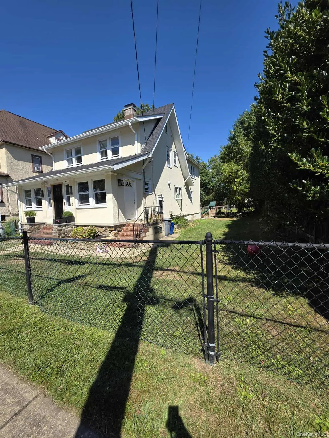 View of front facade featuring a chimney and stucco siding View of front facade featuring a chimney and stucco siding