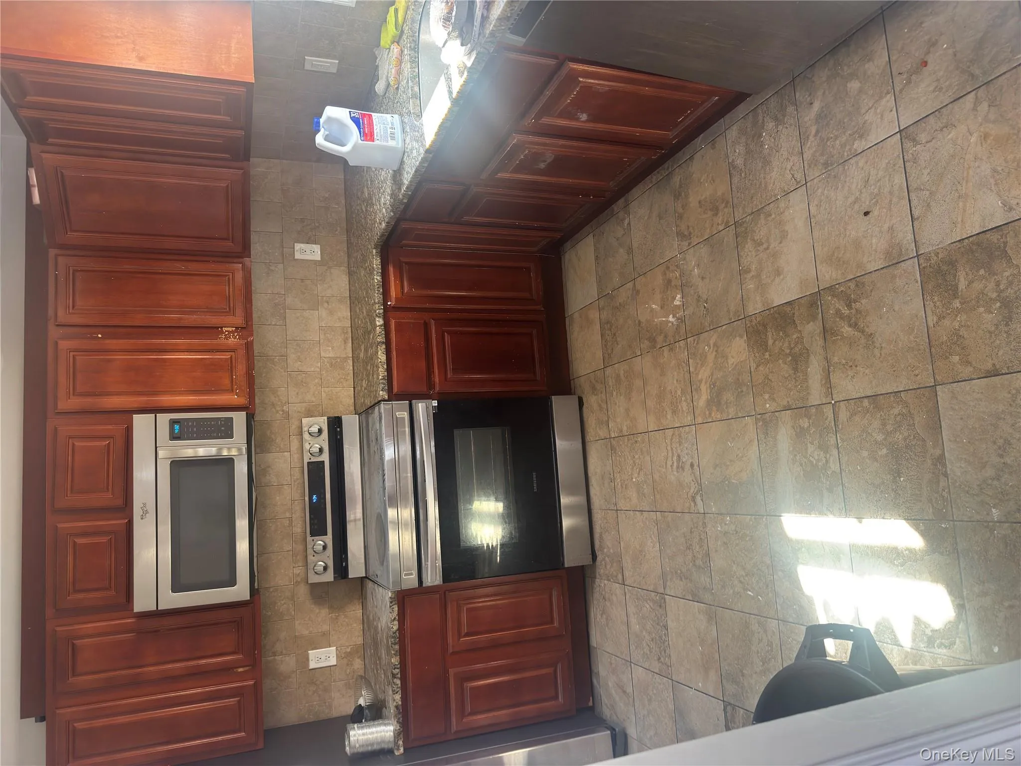 Kitchen featuring stainless steel electric range oven, backsplash, dark stone countertops, and dishwasher Kitchen featuring stainless steel electric range oven, backsplash, dark stone countertops, and dishwasher