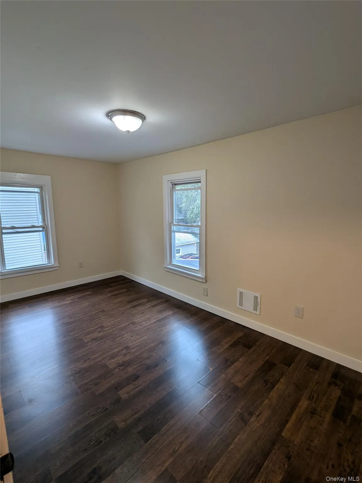 Empty room with dark wood-style floors Empty room with dark wood-style floors