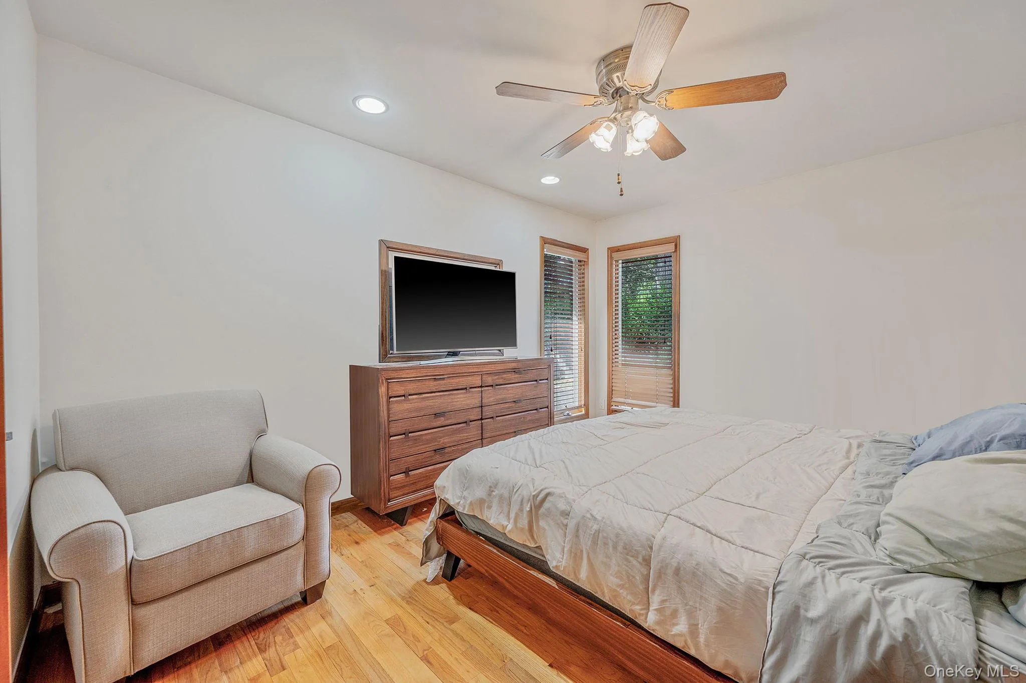Bedroom featuring wood finished floors, recessed lighting, and ceiling fan Bedroom featuring wood finished floors, recessed lighting, and ceiling fan