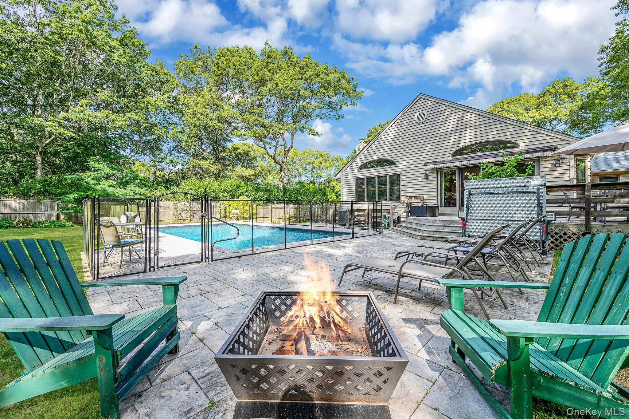 View of swimming pool with a patio area and a fire pit View of swimming pool with a patio area and a fire pit