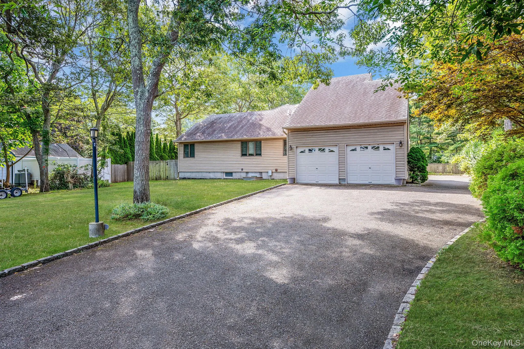 View of front of house with driveway, an attached garage, and a shingled roof View of front of house with driveway, an attached garage, and a shingled roof