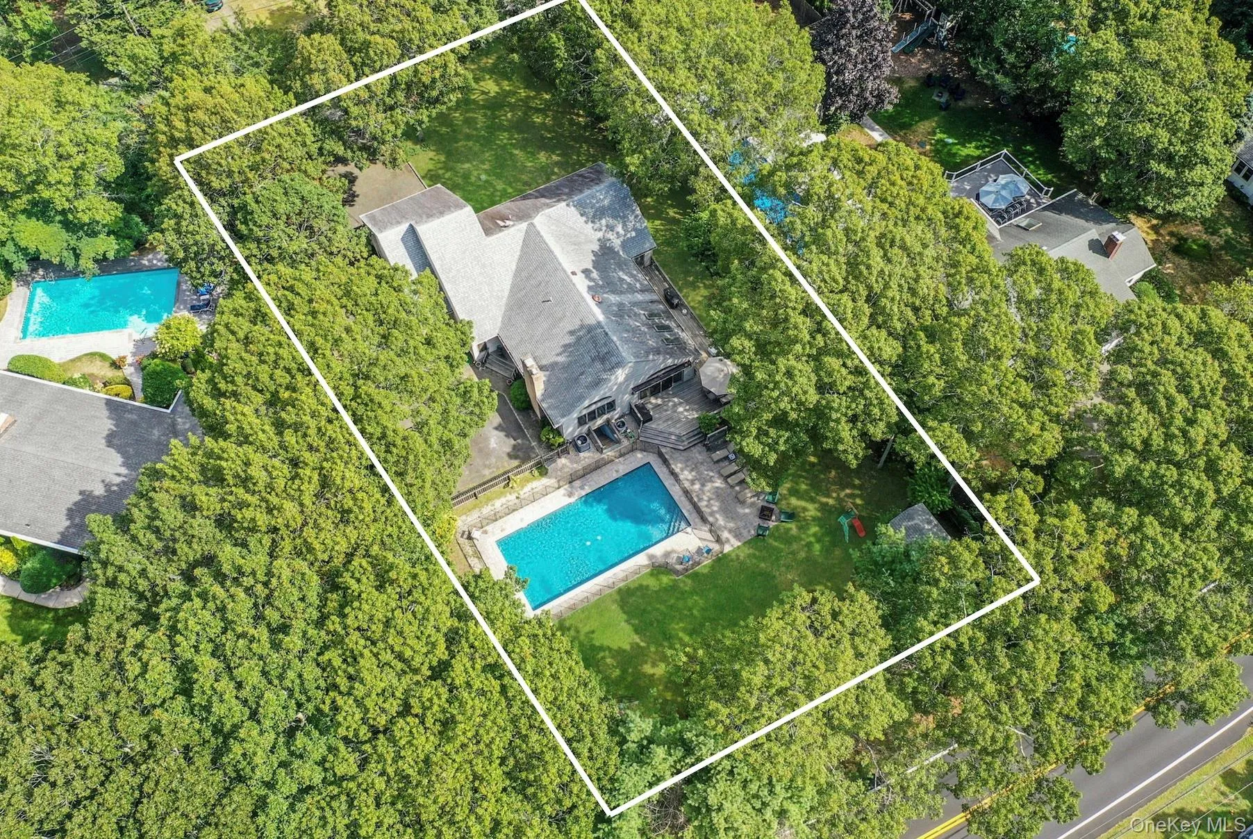 Aerial view of property and surrounding area with property boundaries highlighted Aerial view of property and surrounding area with property boundaries highlighted