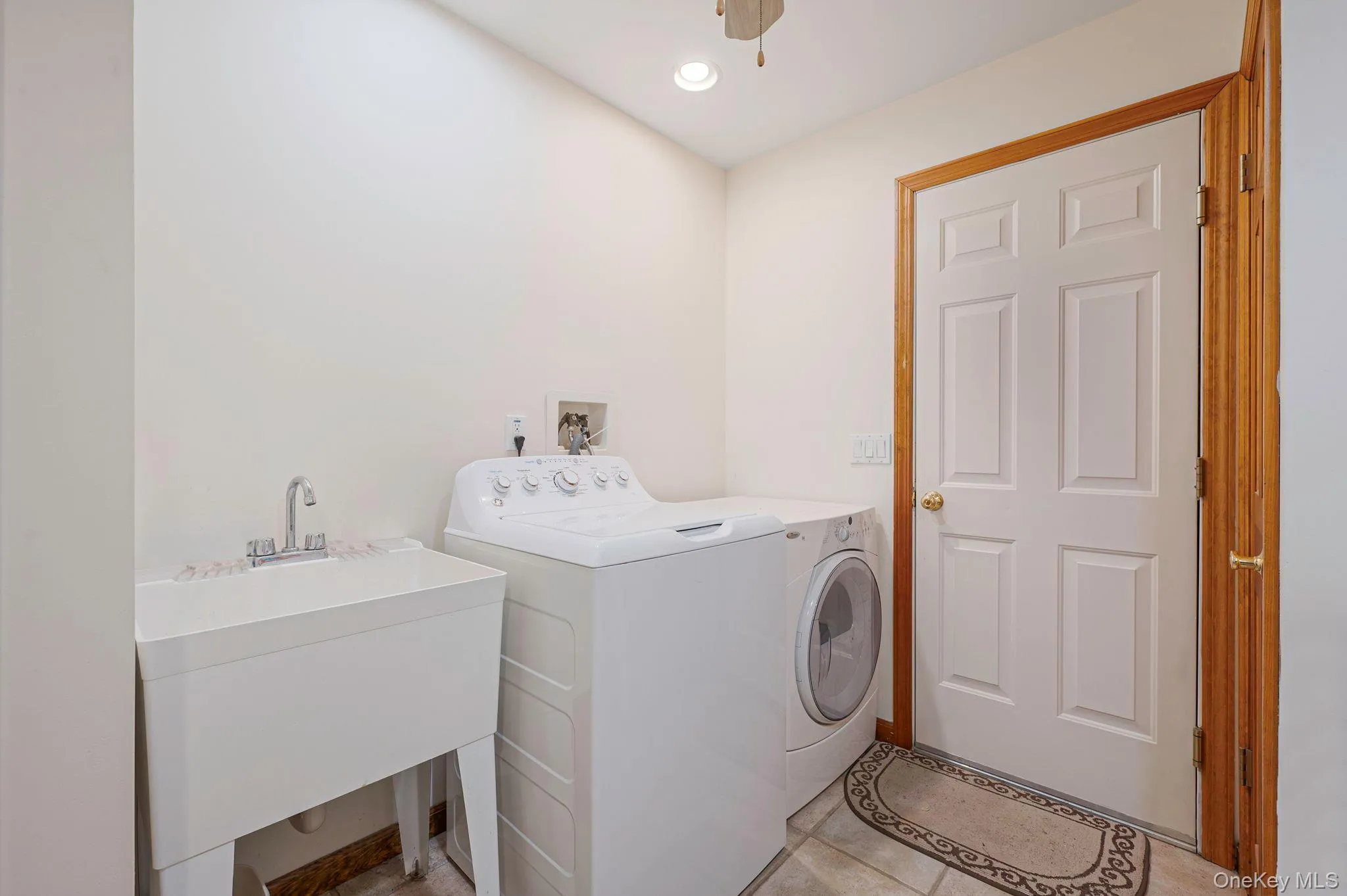 Laundry room with washer and clothes dryer, recessed lighting, and light tile patterned floors Laundry room with washer and clothes dryer, recessed lighting, and light tile patterned floors