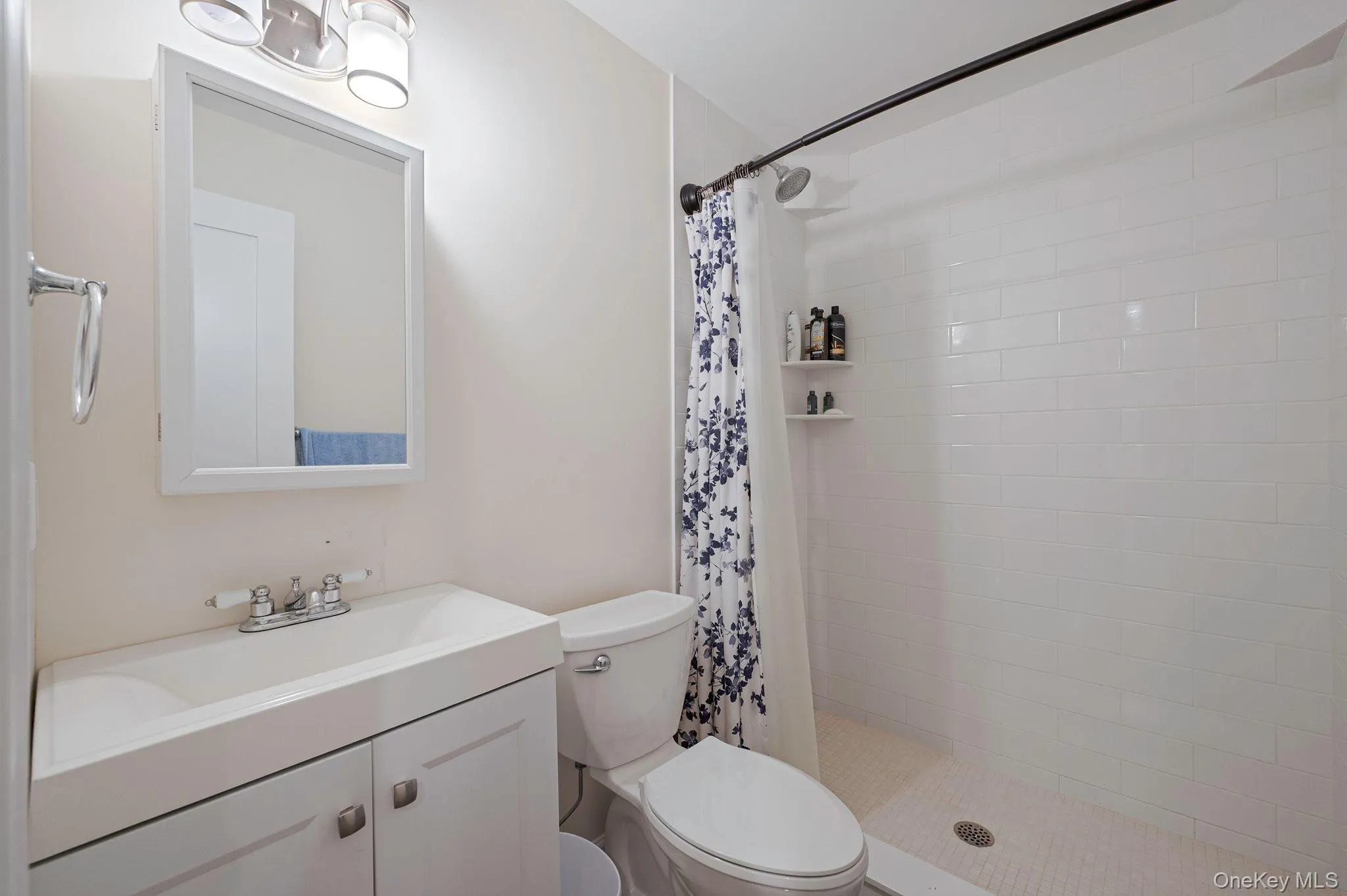 Full bathroom featuring vanity and a stall shower Full bathroom featuring vanity and a stall shower