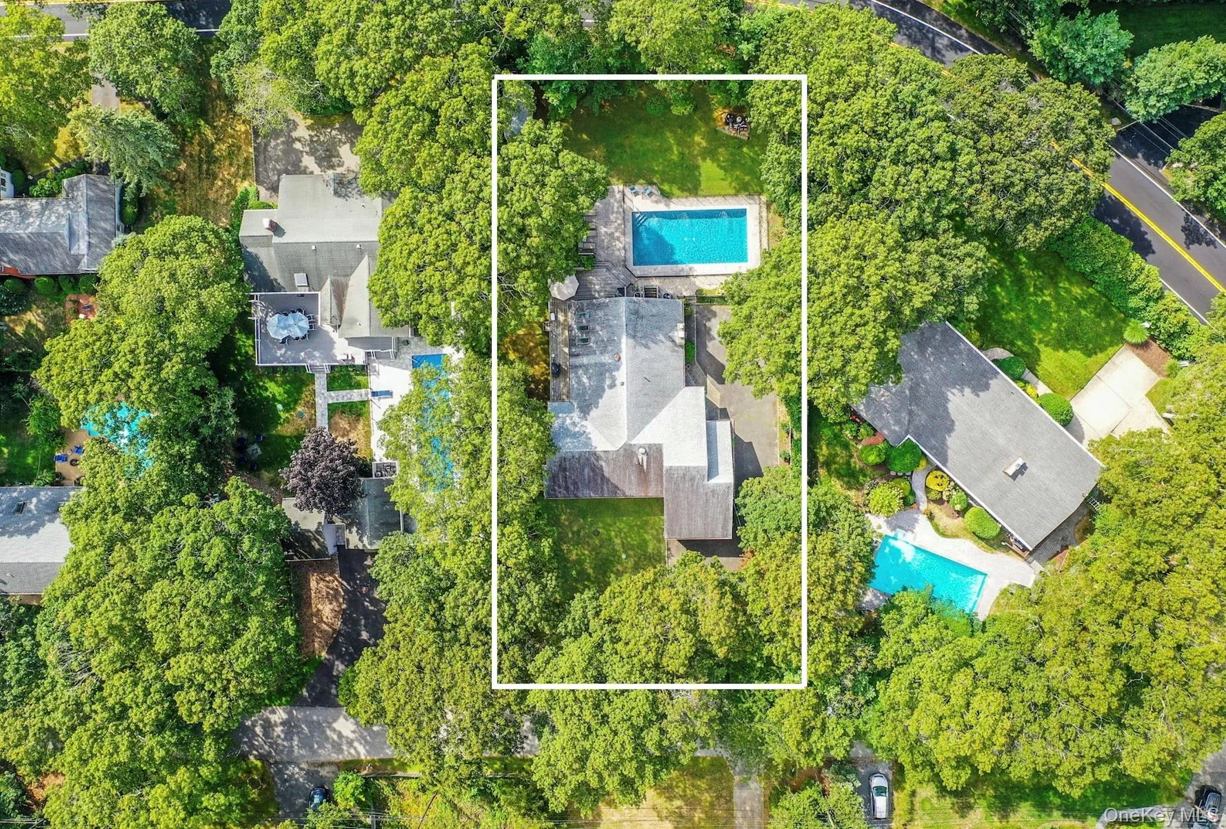 Aerial view of property\'s location featuring a pool and property parcel outlined Aerial view of property\'s location featuring a pool and property parcel outlined