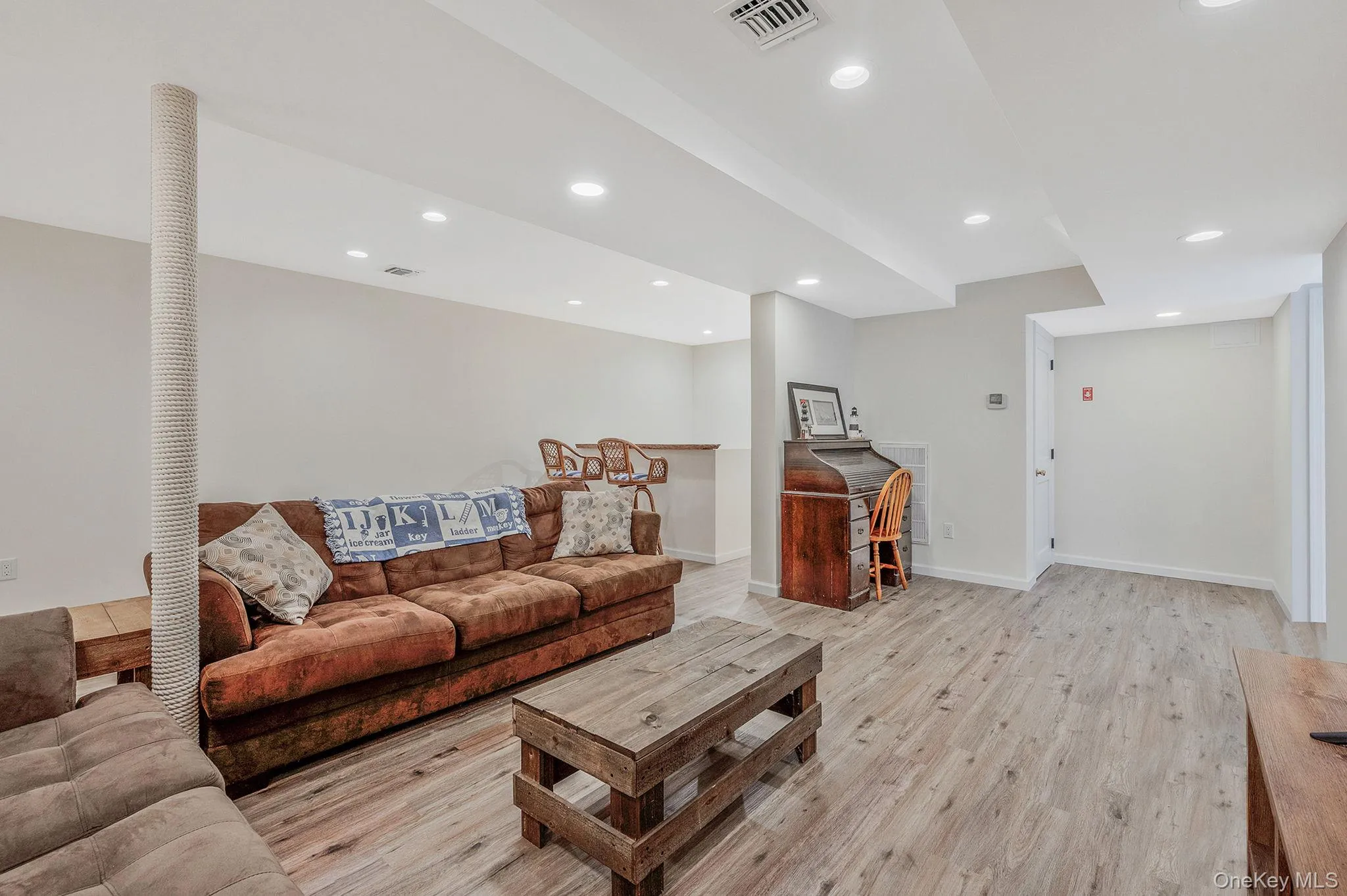 Living area with light wood-style floors, recessed lighting, and bar area Living area with light wood-style floors, recessed lighting, and bar area