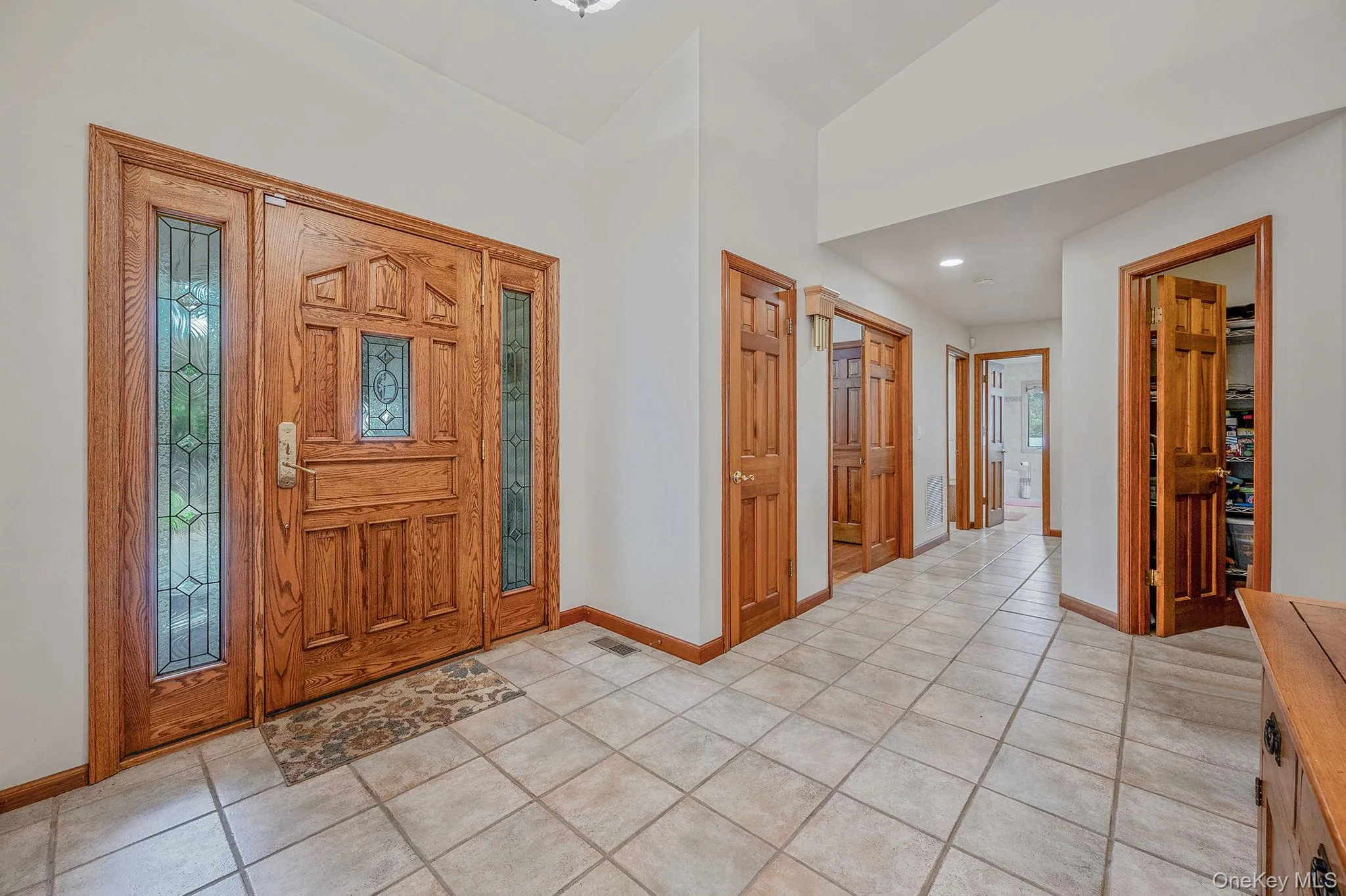 Entryway with light tile patterned flooring, recessed lighting, and plenty of natural light Entryway with light tile patterned flooring, recessed lighting, and plenty of natural light