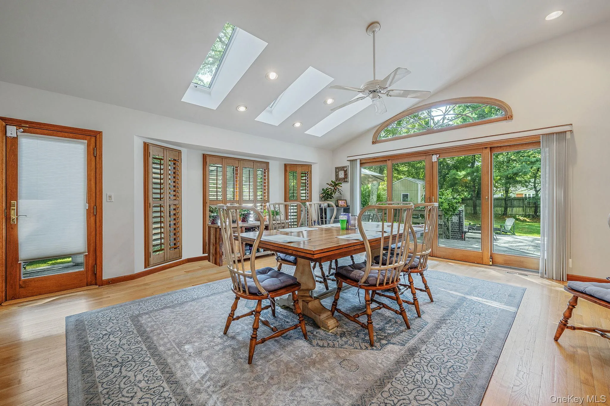 Dining area featuring high vaulted ceiling, healthy amount of natural light, recessed lighting, light wood-style flooring, and ceiling fan Dining area featuring high vaulted ceiling, healthy amount of natural light, recessed lighting, light wood-style flooring, and ceiling fan