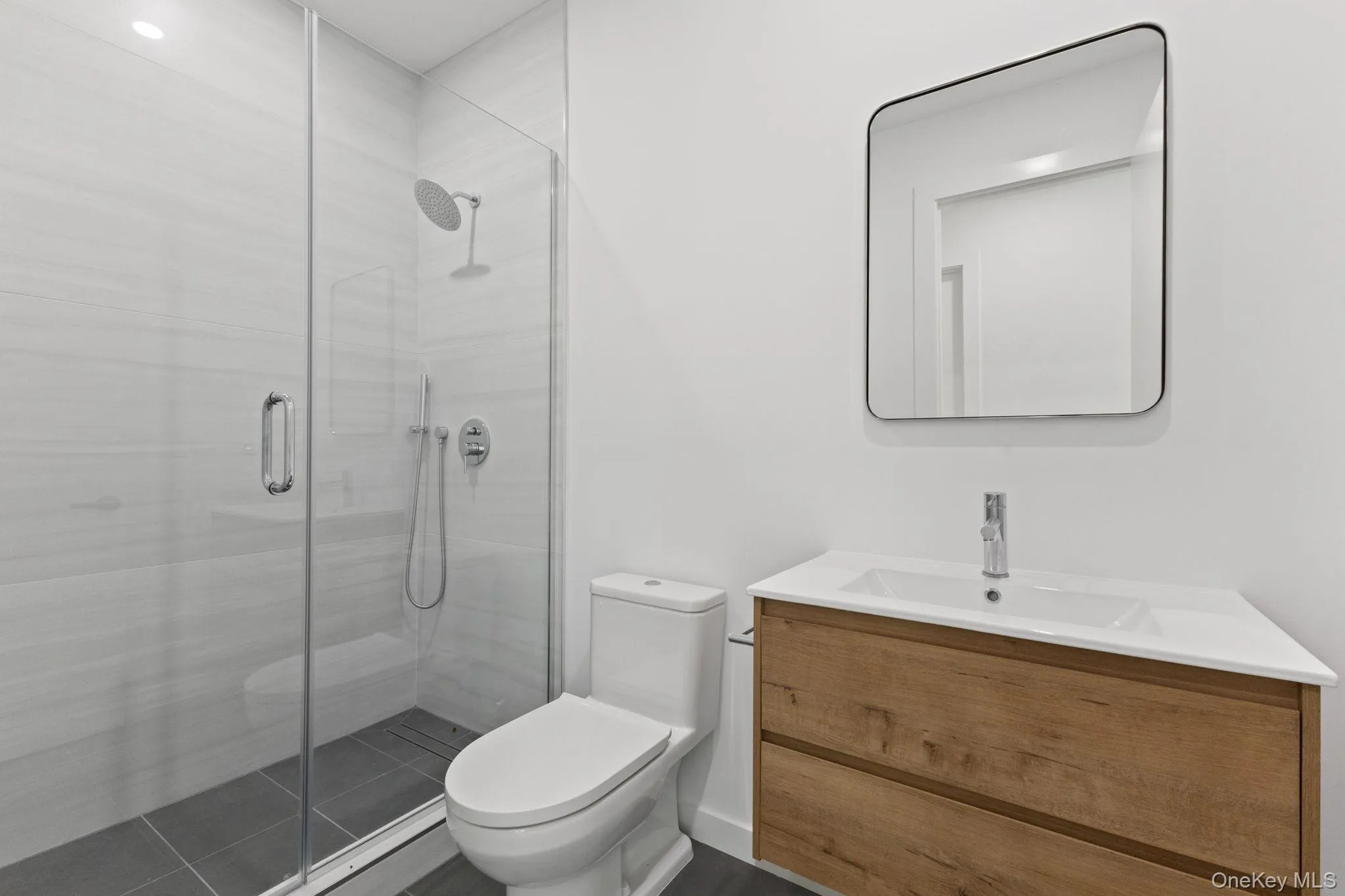 Bathroom featuring vanity and a shower stall Bathroom featuring vanity and a shower stall