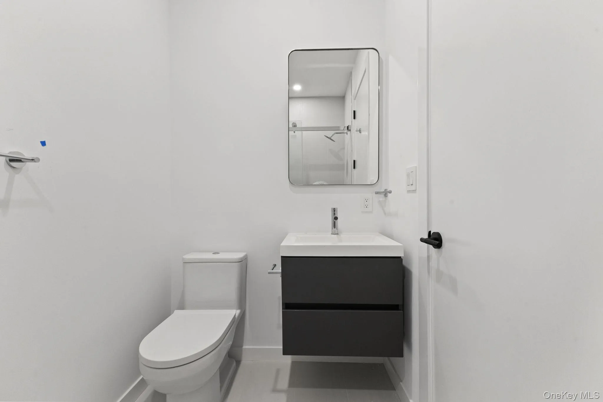 Full bathroom featuring vanity, a shower with shower door, and tile patterned floors Full bathroom featuring vanity, a shower with shower door, and tile patterned floors