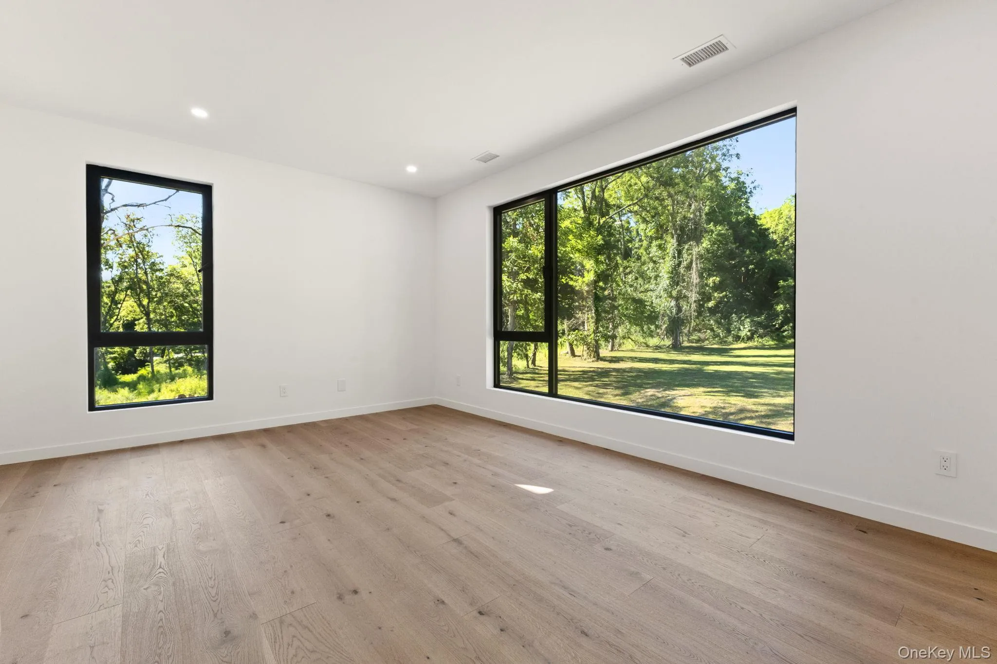 Unfurnished room with plenty of natural light, recessed lighting, and light wood-style flooring Unfurnished room with plenty of natural light, recessed lighting, and light wood-style flooring