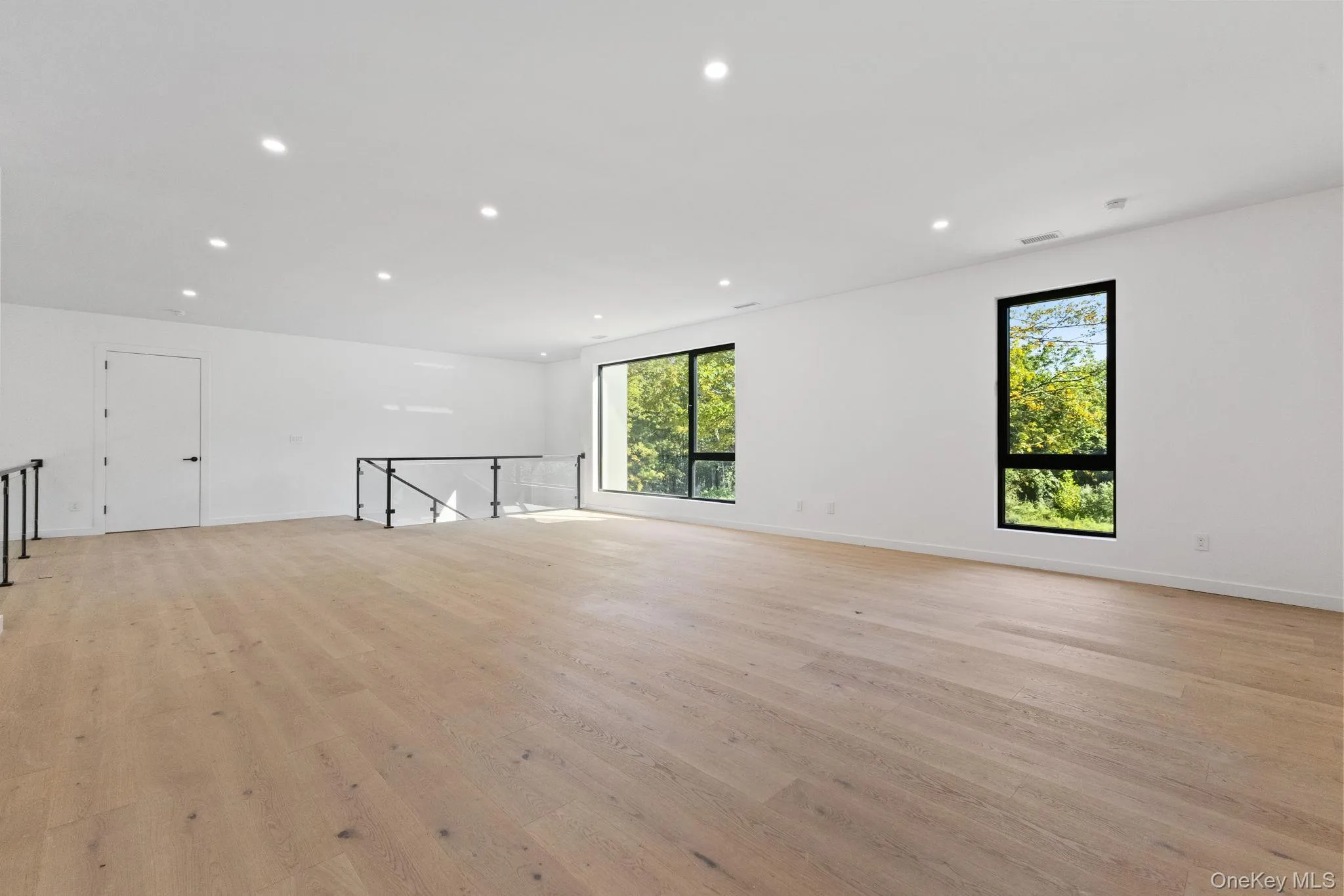 Spare room featuring recessed lighting and light wood-style floors Spare room featuring recessed lighting and light wood-style floors