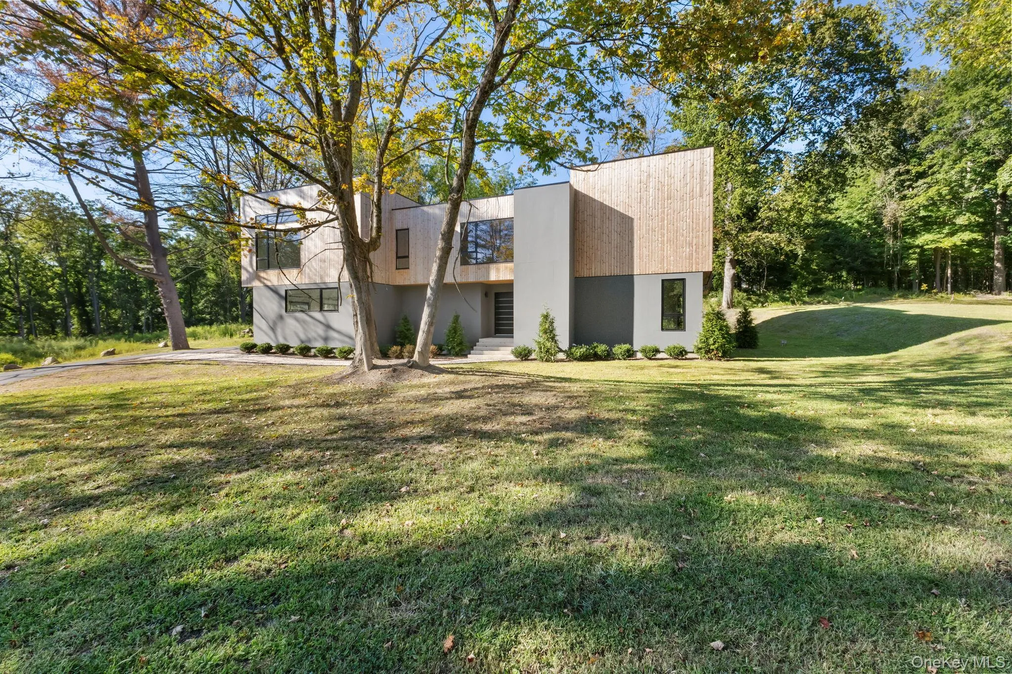View of side of property featuring a lawn and stucco siding View of side of property featuring a lawn and stucco siding