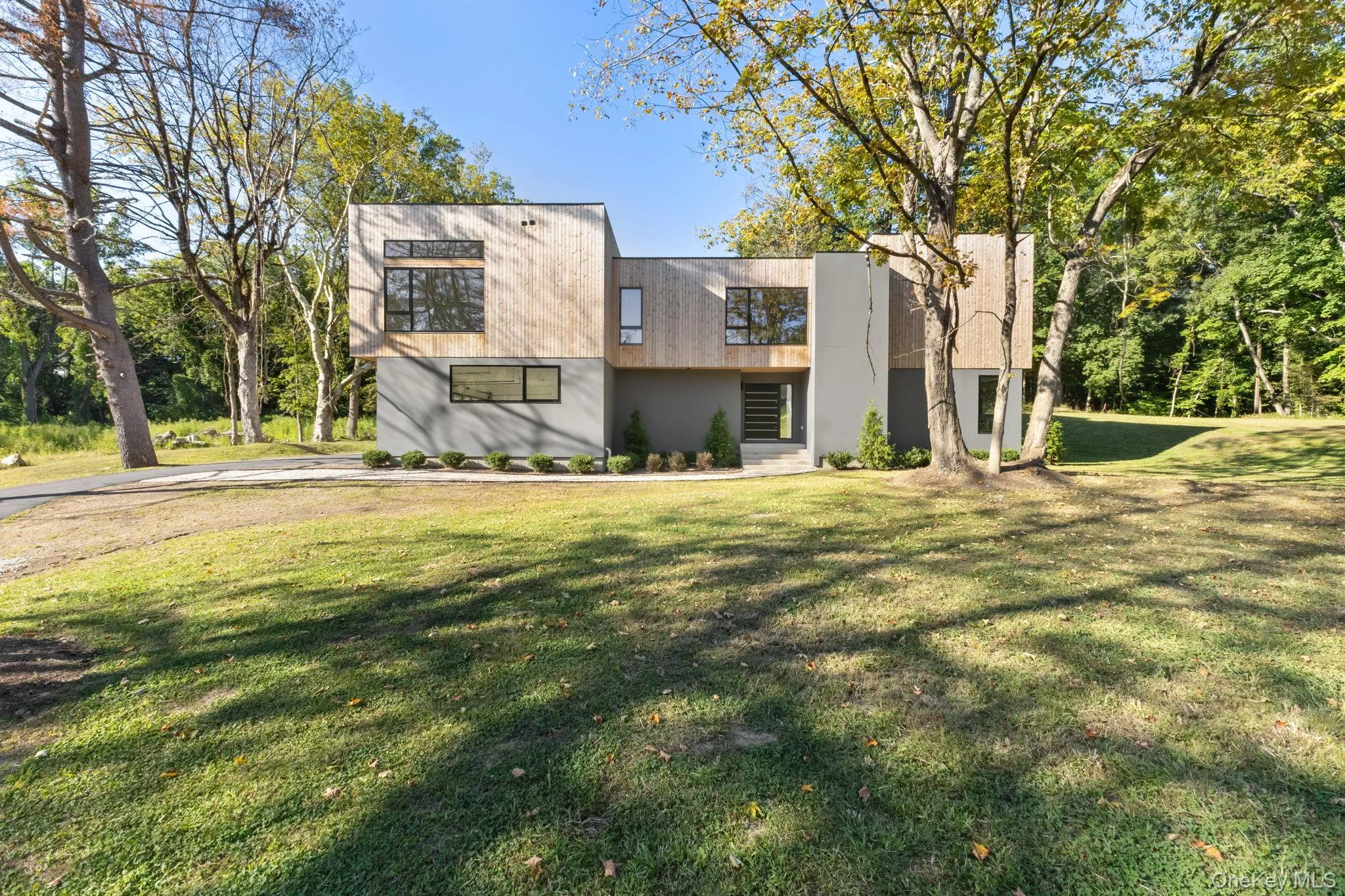 Contemporary home with a front yard and stucco siding Contemporary home with a front yard and stucco siding