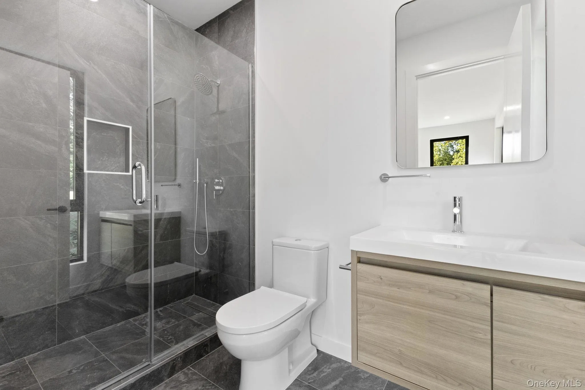 Bathroom with vanity and a shower stall Bathroom with vanity and a shower stall