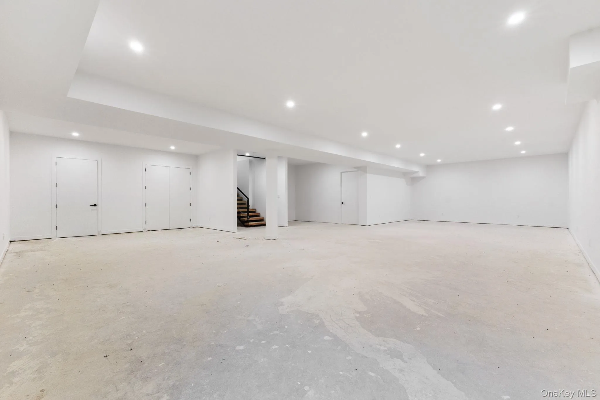 Finished below grade area with recessed lighting and stairs Finished below grade area with recessed lighting and stairs