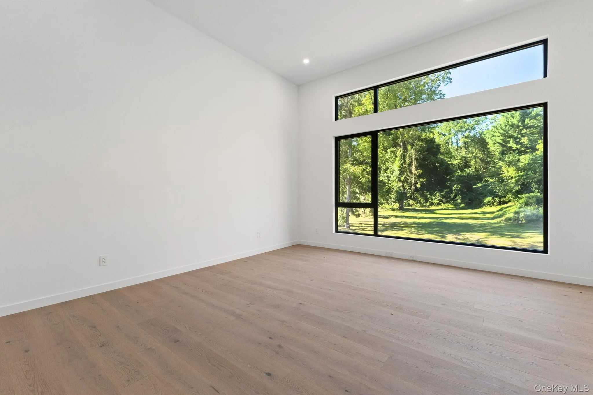 Empty room featuring light wood finished floors and recessed lighting Empty room featuring light wood finished floors and recessed lighting