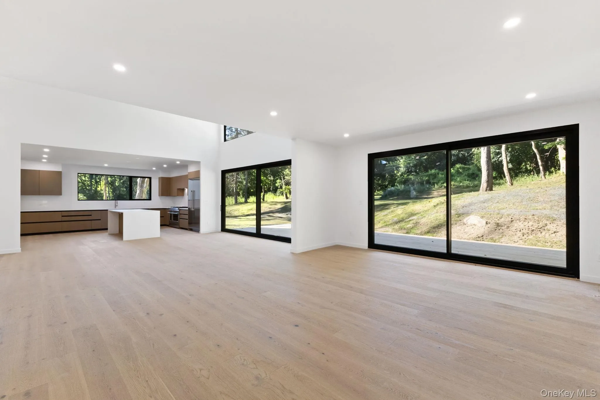 Unfurnished living room with recessed lighting and light wood-style flooring Unfurnished living room with recessed lighting and light wood-style flooring