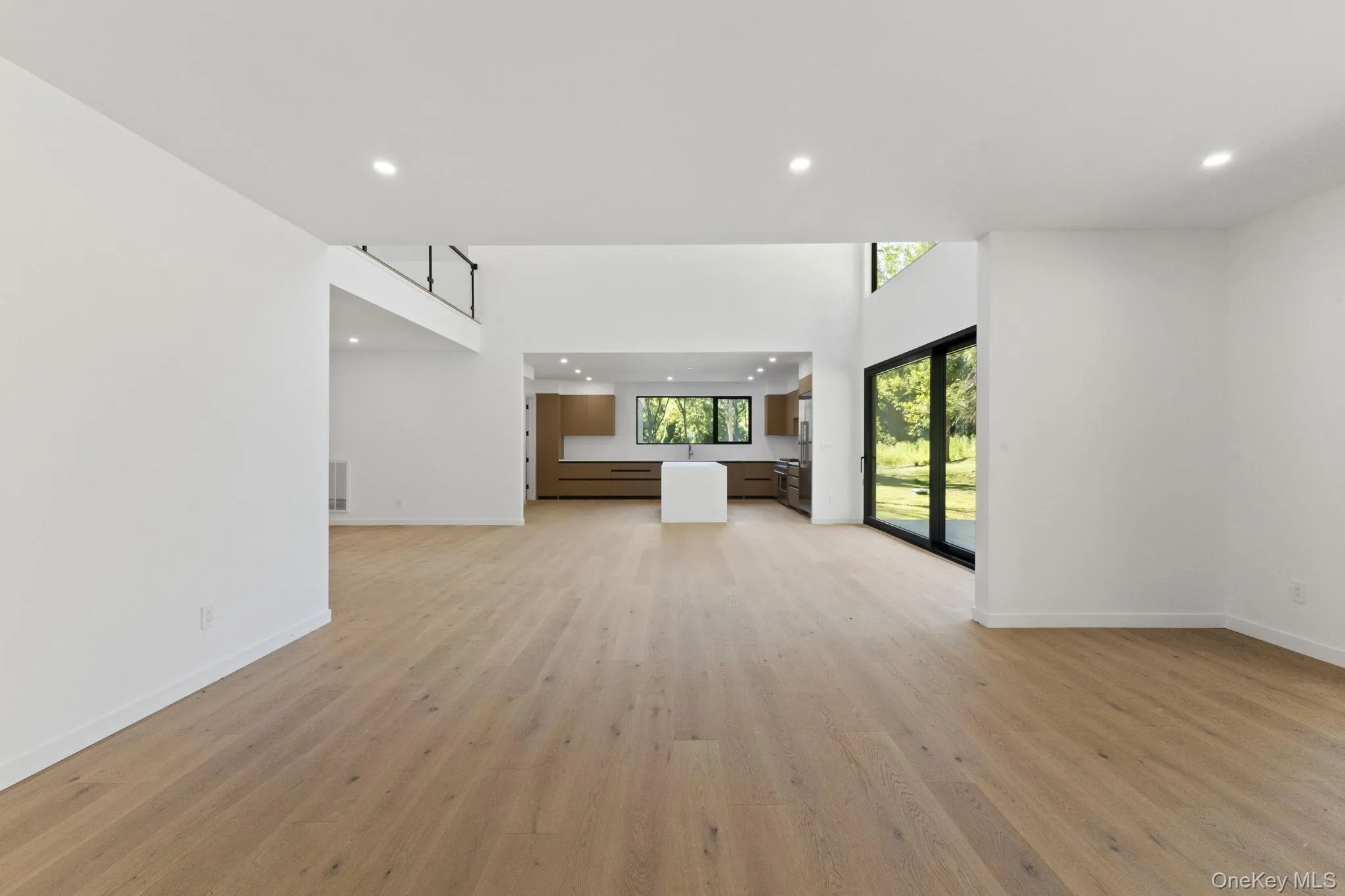 Unfurnished living room featuring recessed lighting and light wood-type flooring Unfurnished living room featuring recessed lighting and light wood-type flooring
