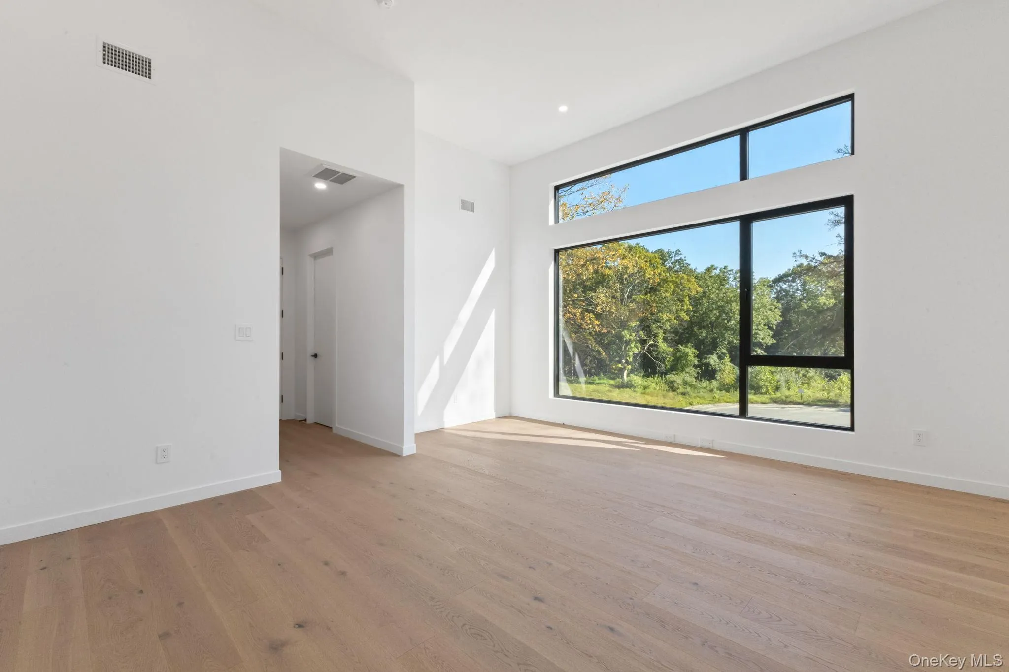 Unfurnished room featuring light wood-style flooring and recessed lighting Unfurnished room featuring light wood-style flooring and recessed lighting
