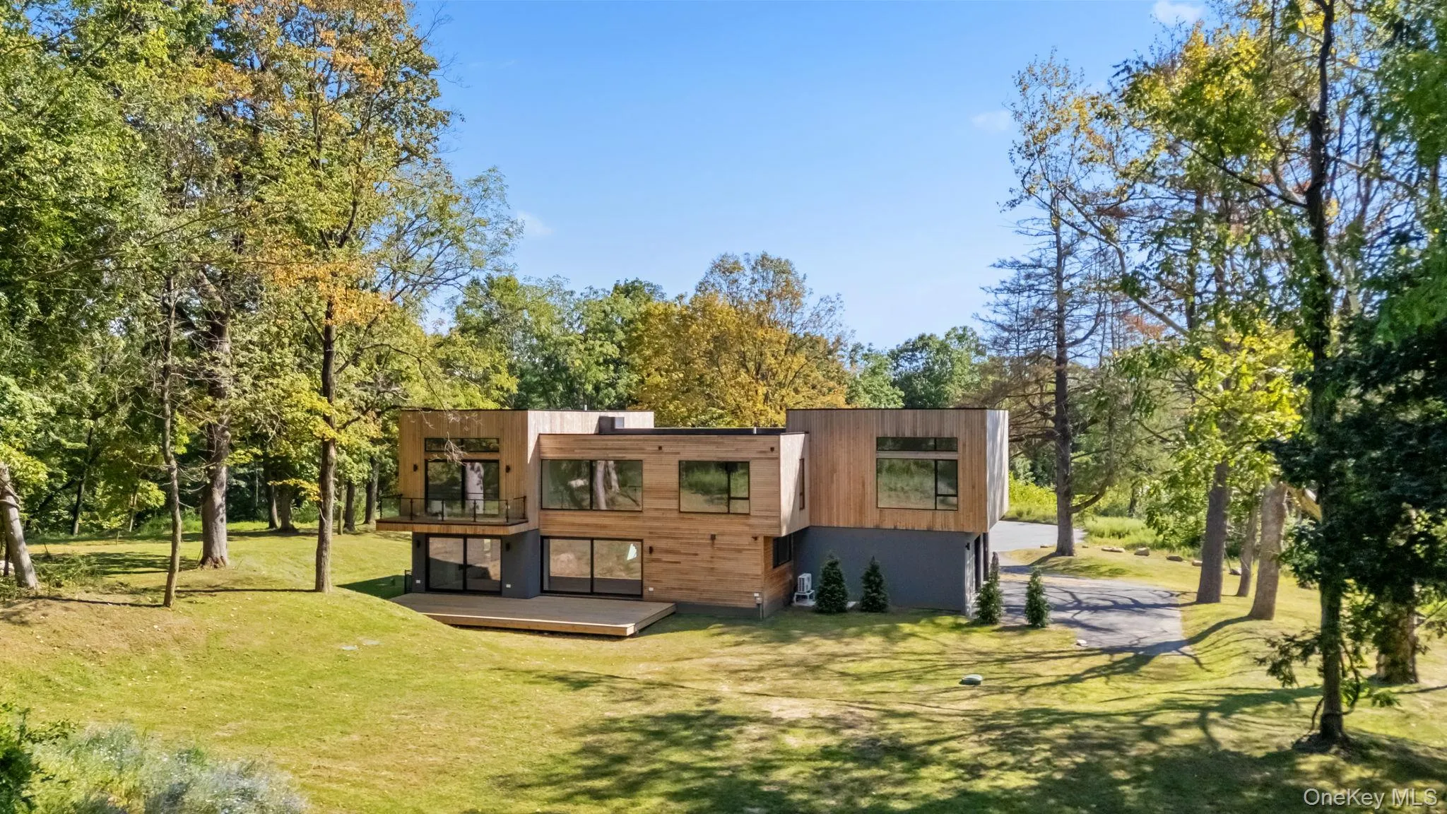 Back of property featuring a deck and a yard Back of property featuring a deck and a yard