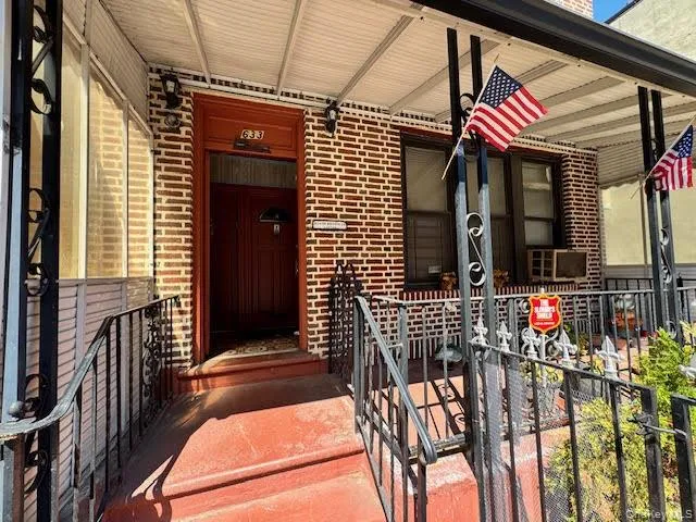 Entrance to property featuring brick siding and covered porch Entrance to property featuring brick siding and covered porch