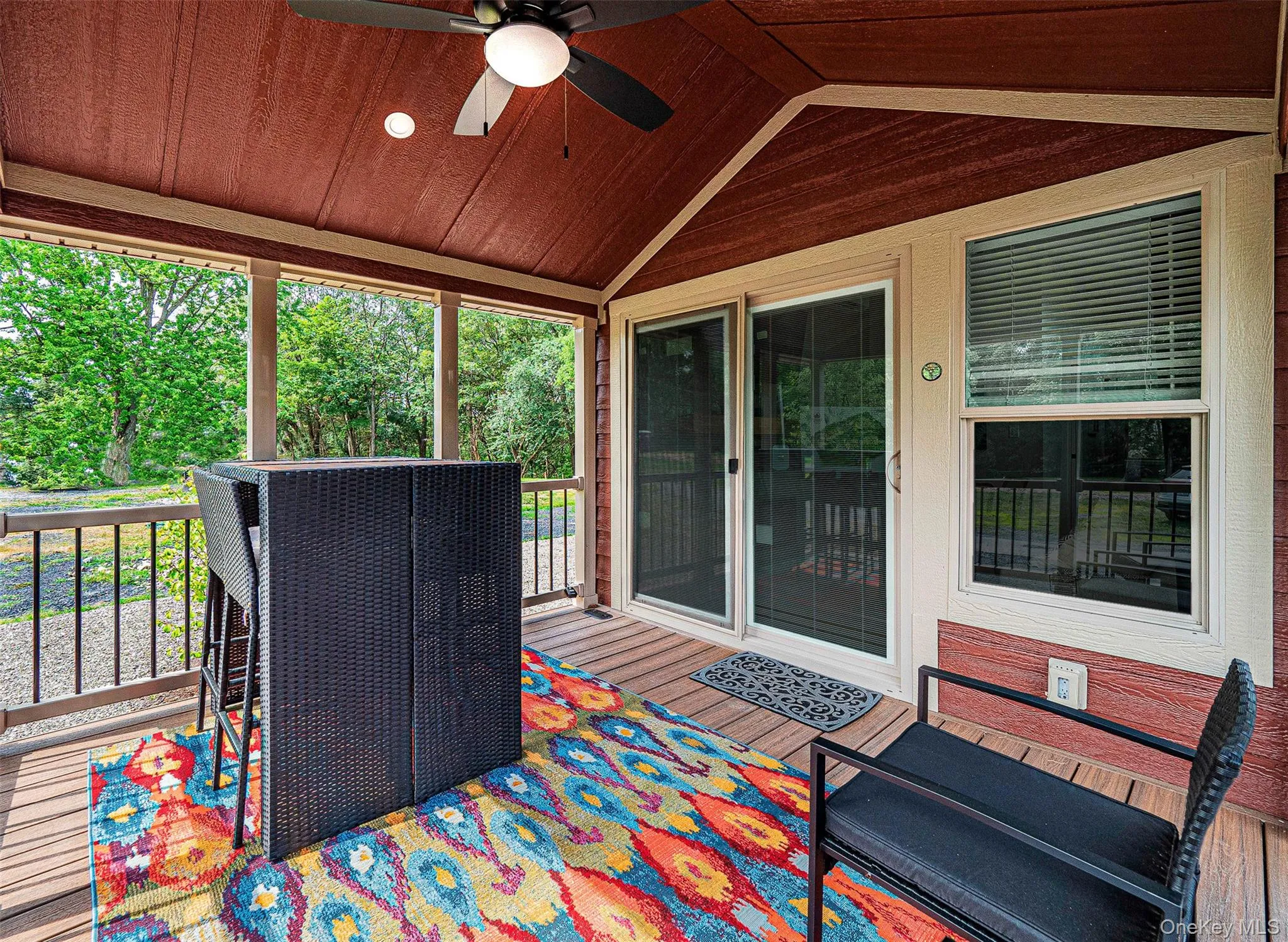 Sunroom / front porch featuring a wooden deck, a ceiling fan, and plenty of natural light Sunroom / front porch featuring a wooden deck, a ceiling fan, and plenty of natural light