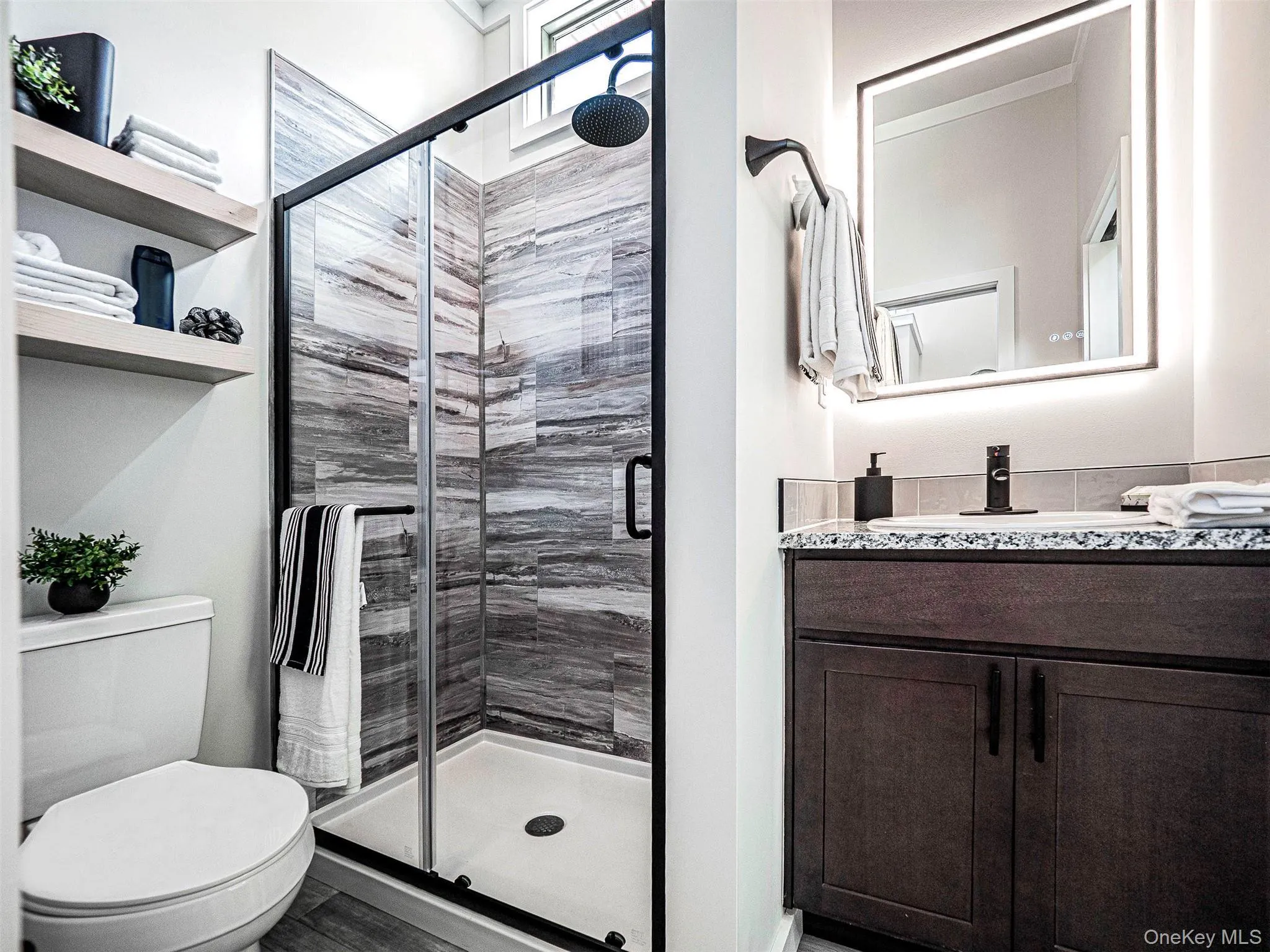 Full bath featuring granite stone-top vanity and a shower stall Full bath featuring granite stone-top vanity and a shower stall