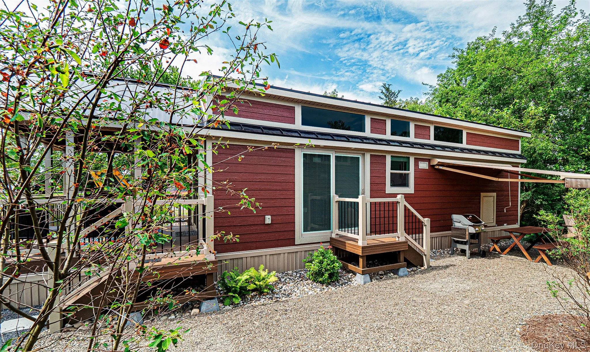 Side view of property featuring a metal roof and a wooden deck Side view of property featuring a metal roof and a wooden deck