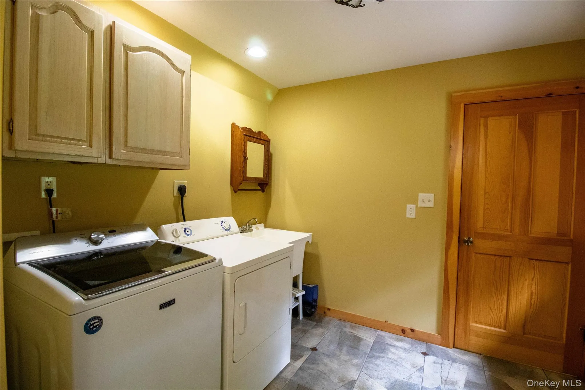 Washroom with washer and clothes dryer, cabinet space, and recessed lighting Washroom with washer and clothes dryer, cabinet space, and recessed lighting