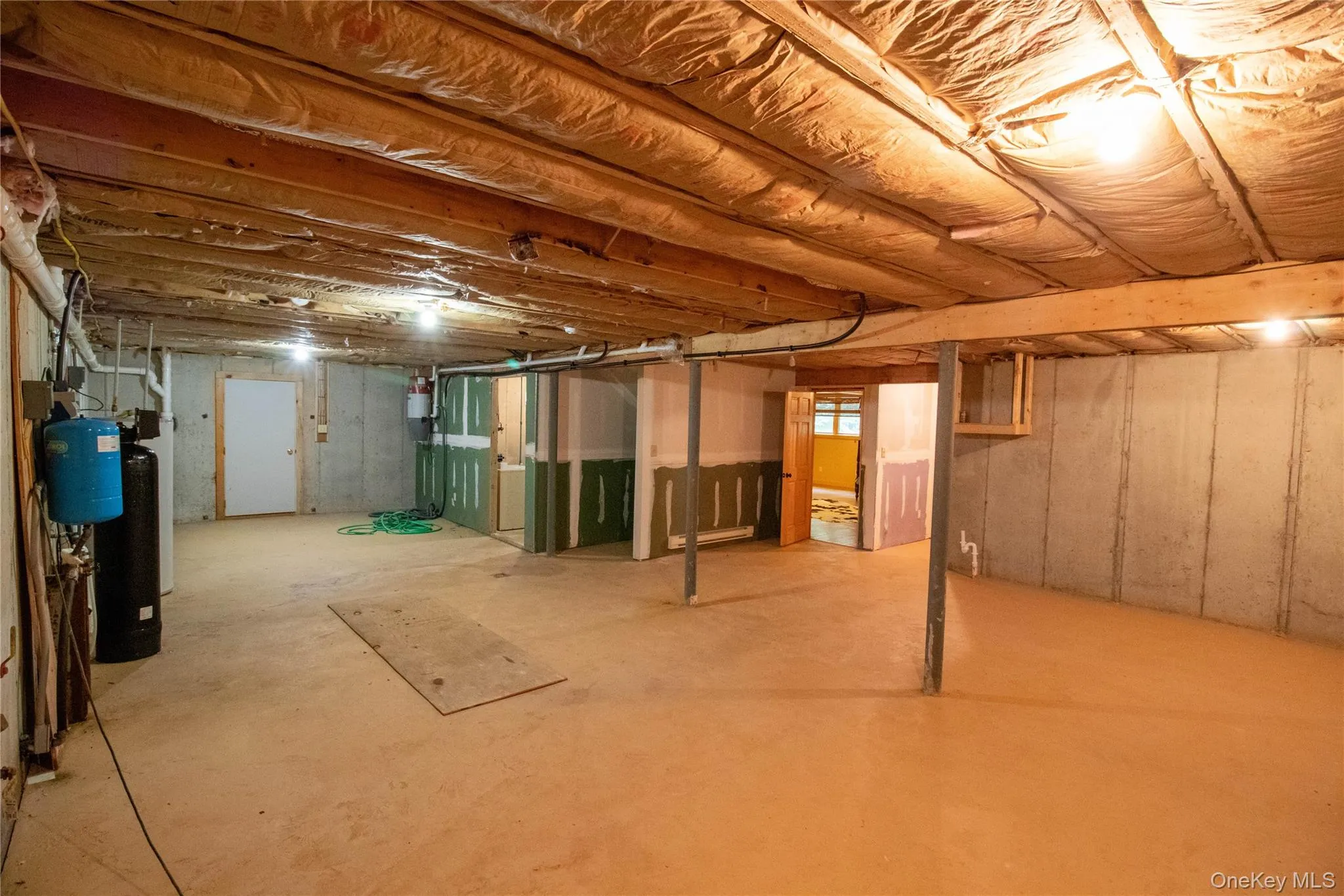 Unfinished basement featuring a water softener Unfinished basement featuring a water softener