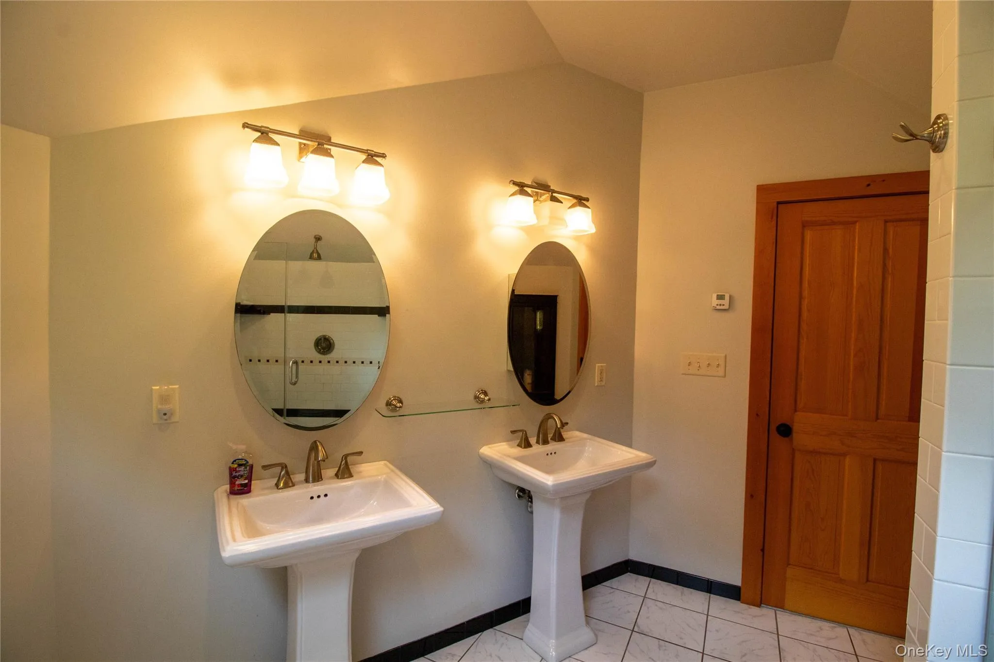 Bathroom with a stall shower and baseboards Bathroom with a stall shower and baseboards