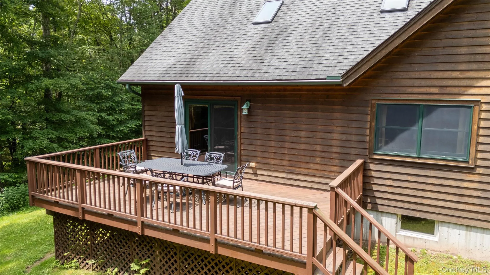Wooden terrace featuring outdoor dining area Wooden terrace featuring outdoor dining area