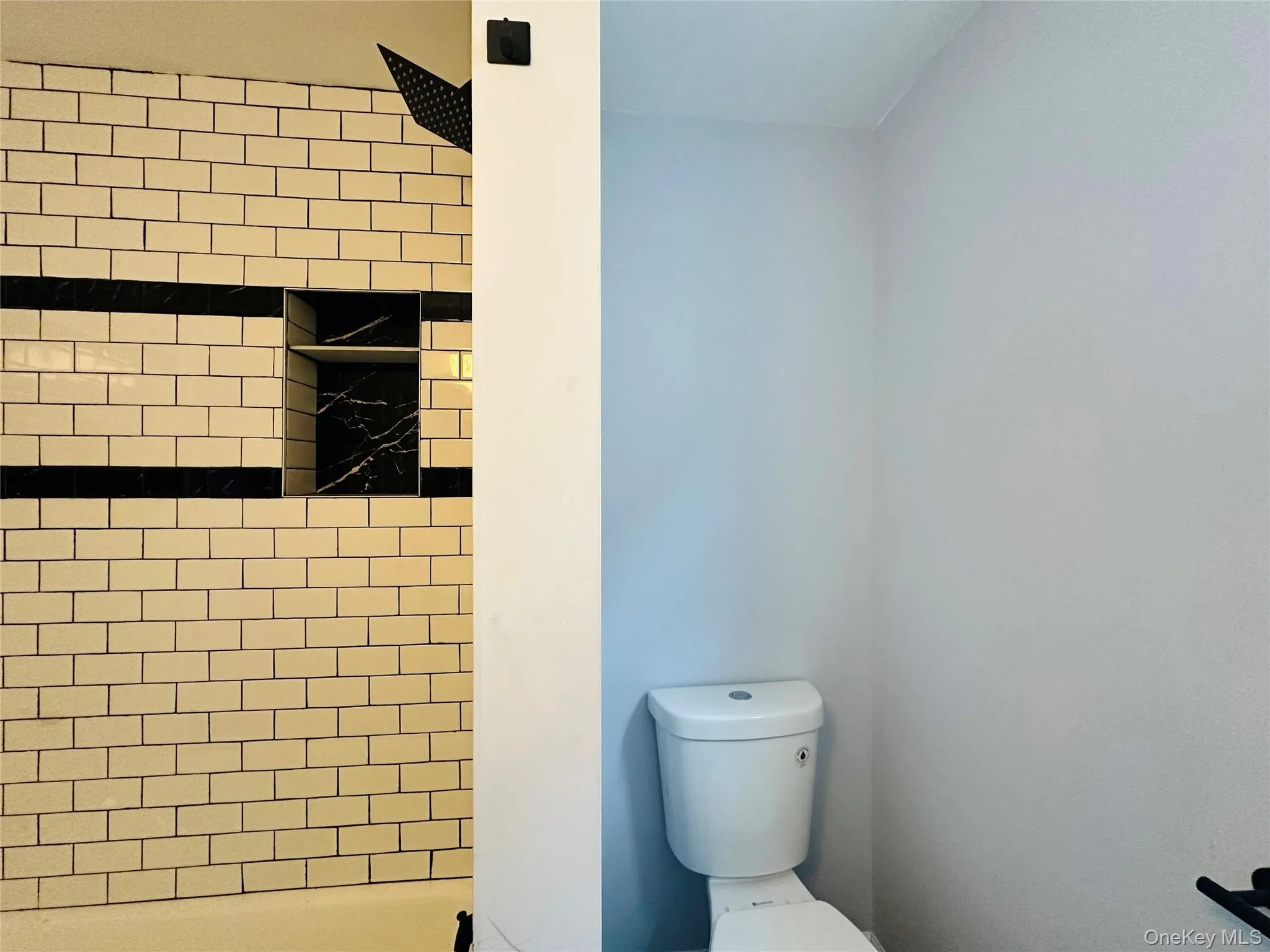 Full bath featuring a shower stall Full bath featuring a shower stall