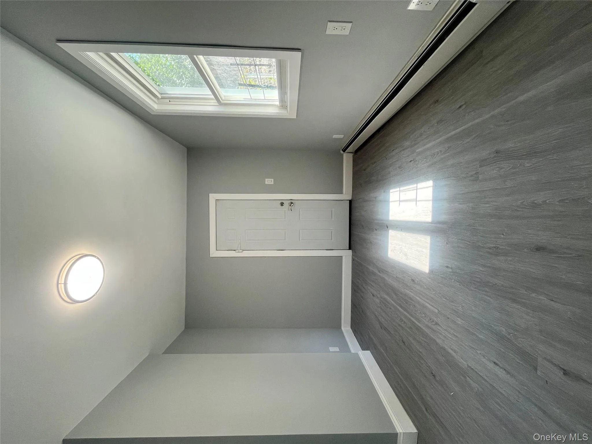 Spare room featuring a baseboard radiator and wood finished floors Spare room featuring a baseboard radiator and wood finished floors
