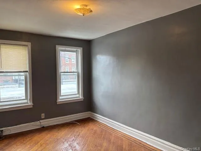Empty room with wood finished floors and baseboards Empty room with wood finished floors and baseboards