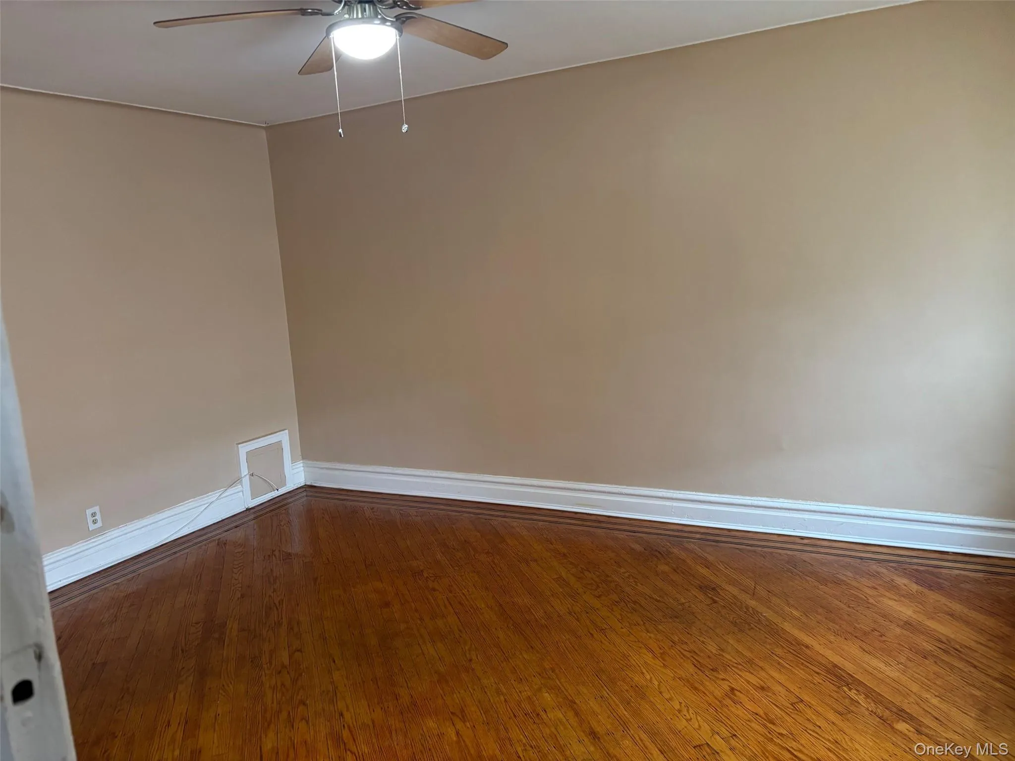 Empty room featuring wood finished floors and ceiling fan Empty room featuring wood finished floors and ceiling fan