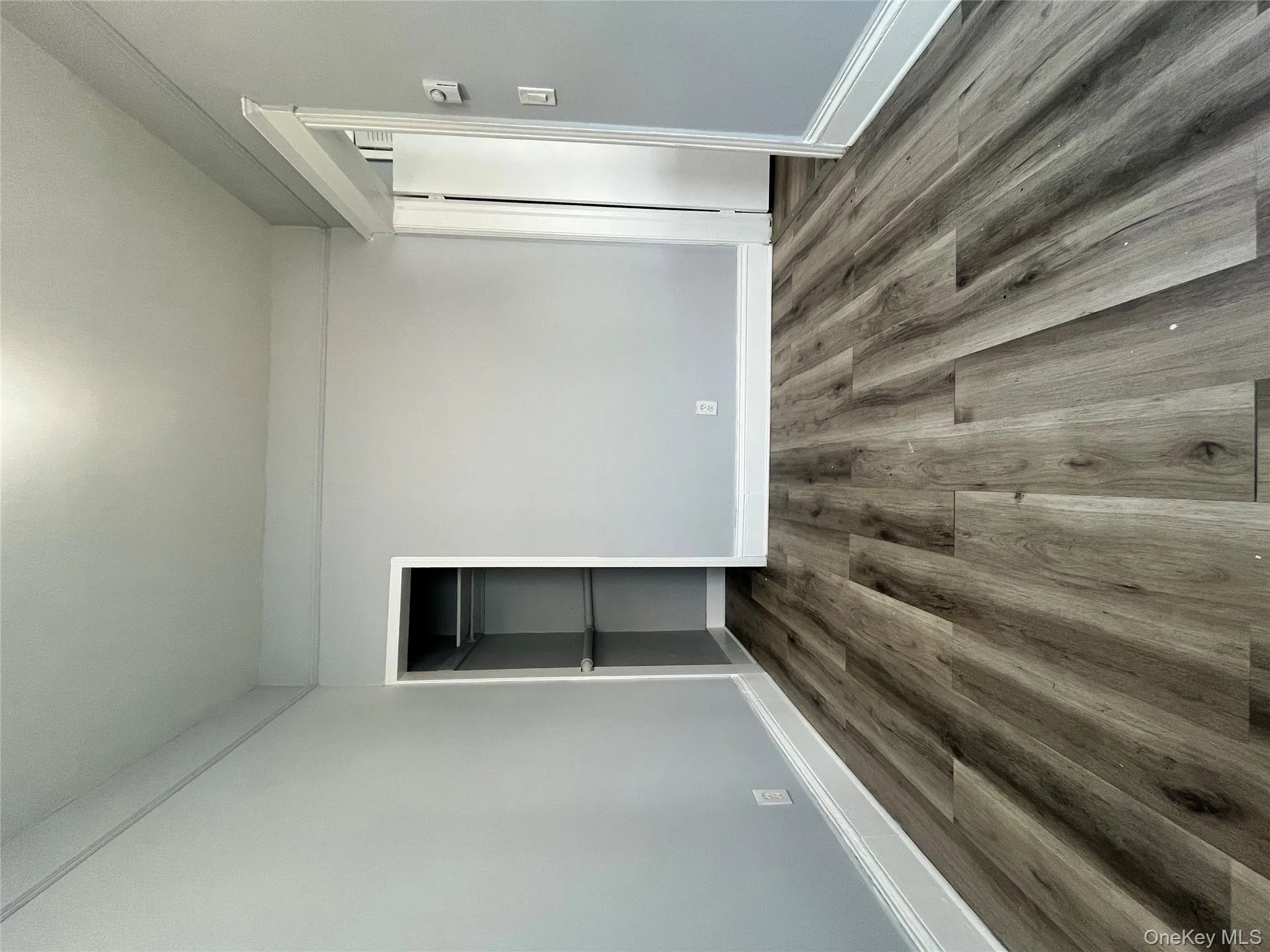 Unfurnished bedroom featuring wood finished floors and a closet Unfurnished bedroom featuring wood finished floors and a closet