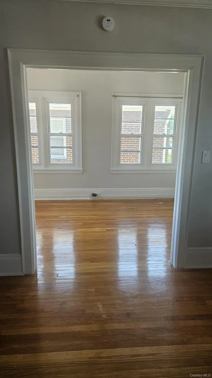Unfurnished room featuring dark wood-style floors Unfurnished room featuring dark wood-style floors