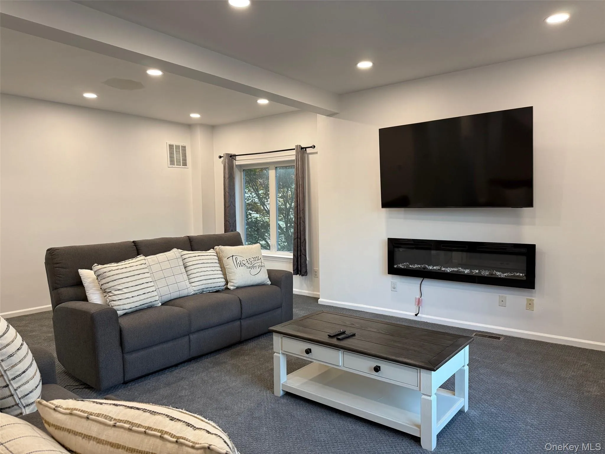 Living area with recessed lighting and carpet flooring Living area with recessed lighting and carpet flooring