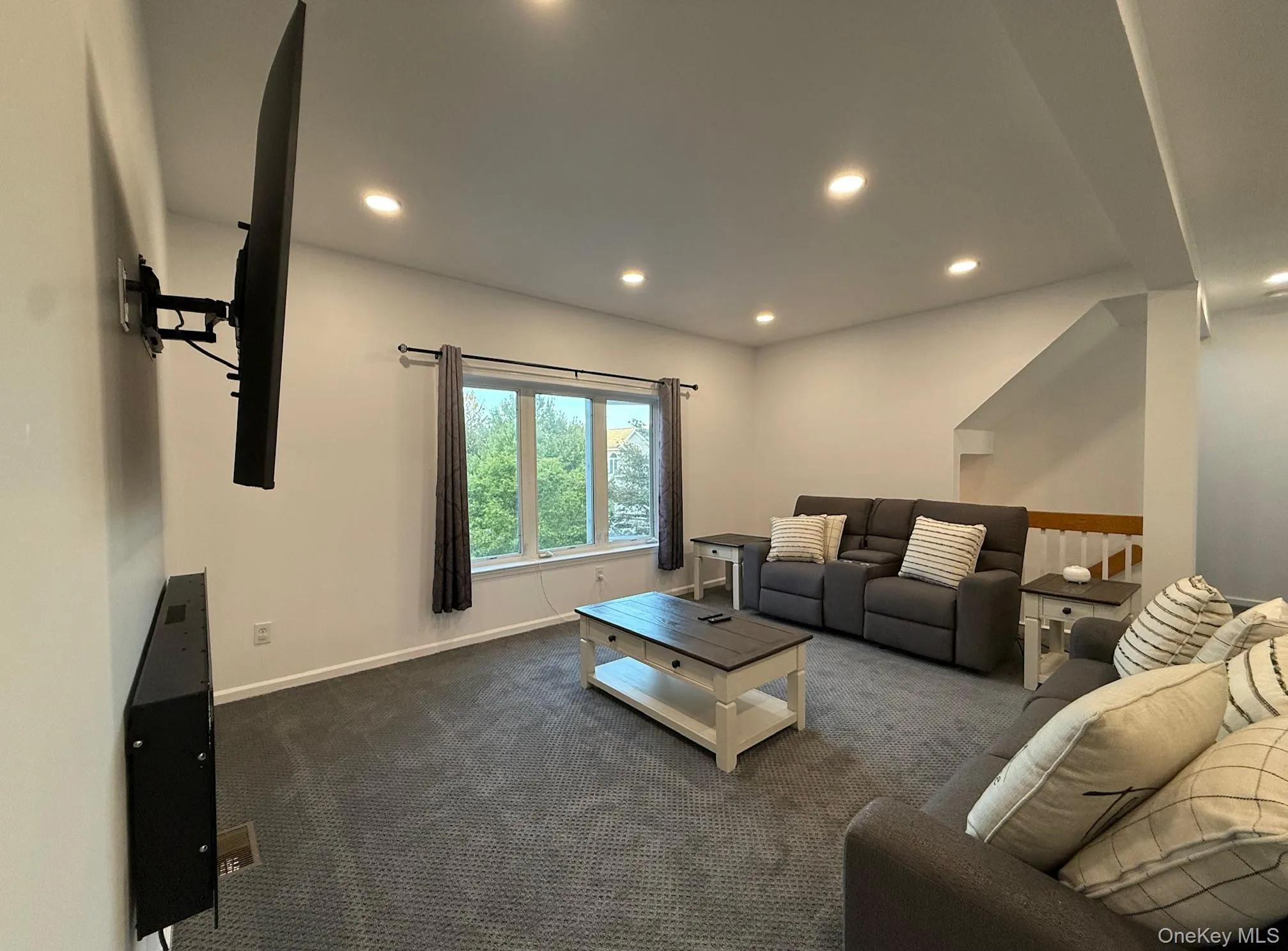 Living area with carpet flooring and recessed lighting Living area with carpet flooring and recessed lighting