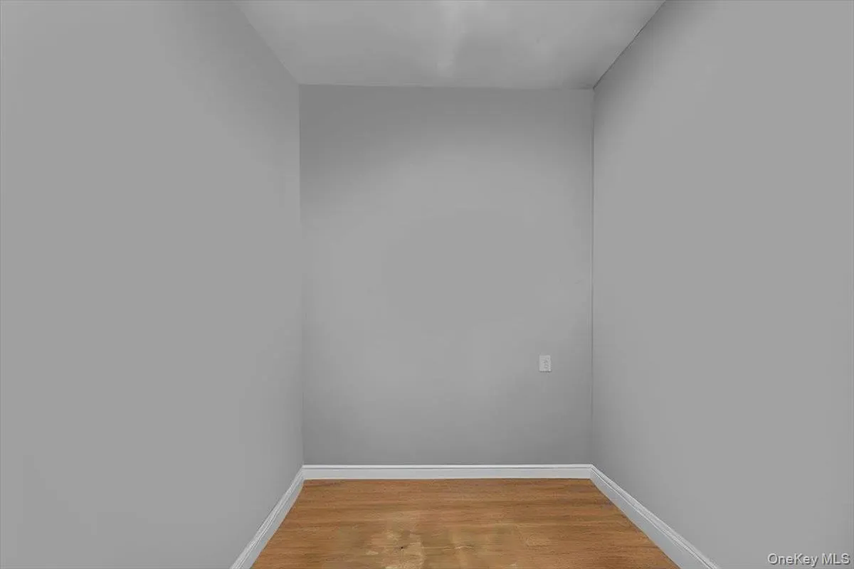 Unfurnished room with light wood-type flooring and baseboards Unfurnished room with light wood-type flooring and baseboards