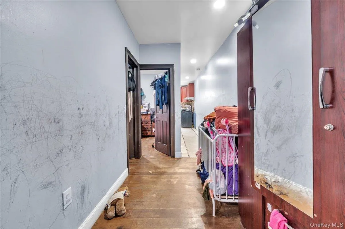 Hall with hardwood / wood-style floors and recessed lighting Hall with hardwood / wood-style floors and recessed lighting