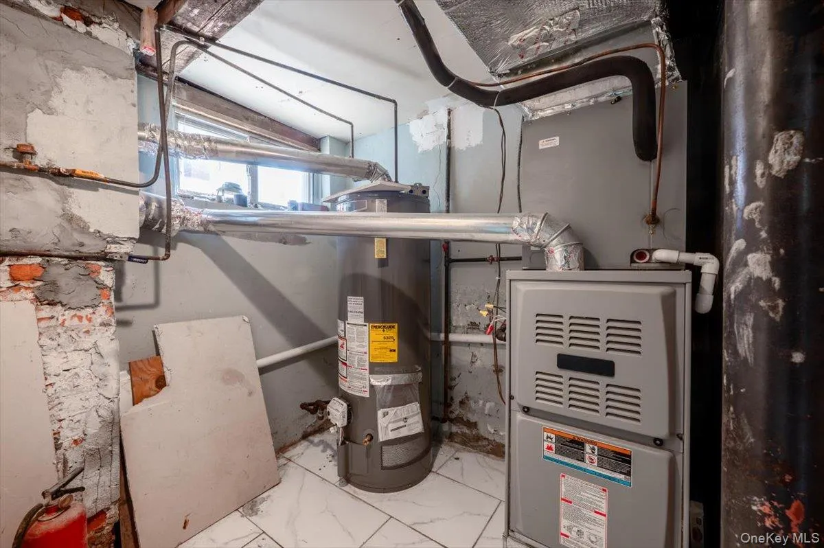 Utility room featuring water heater Utility room featuring water heater